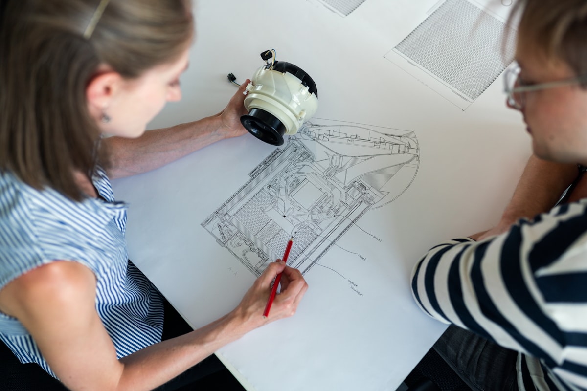 Urban Refit senior project manager reviewing commercial architectural blueprints and electrical compliance documentation